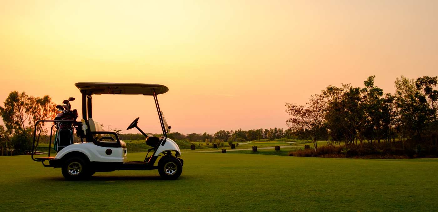 golf buggy on course at sunset