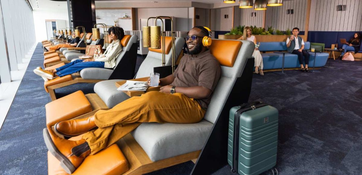 man sitting in recliner at airport lounge