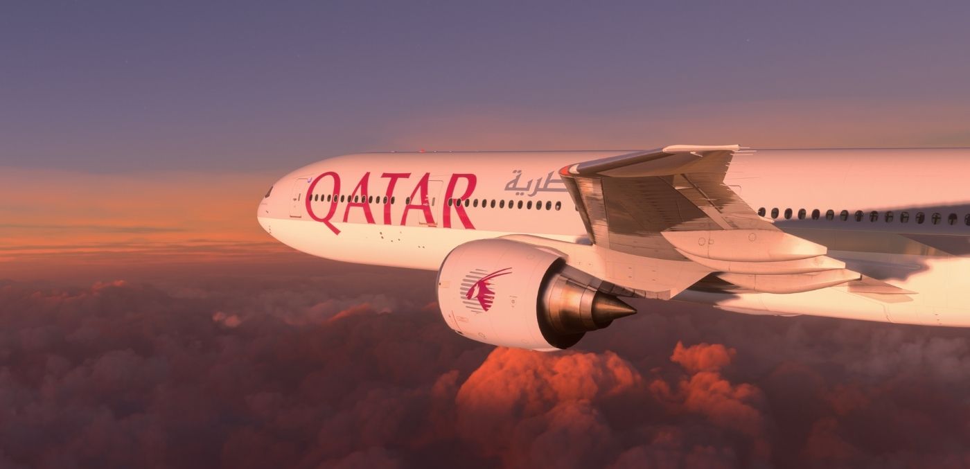 qatar plane in the clouds at sunset