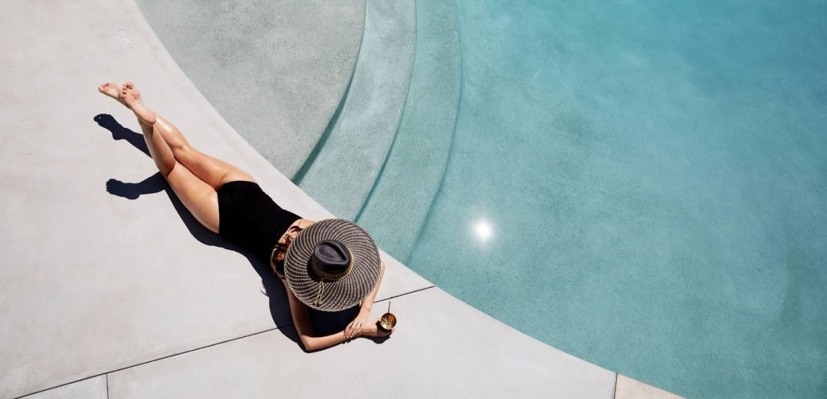 woman laying by pool