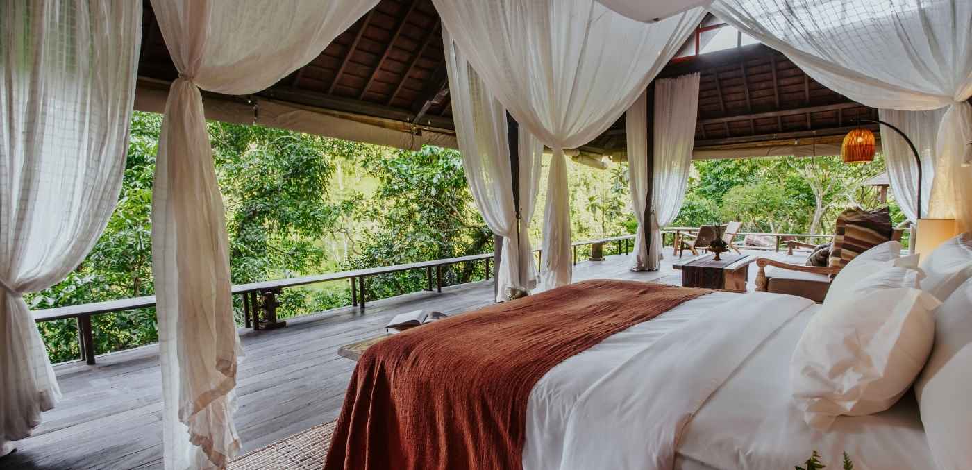 open-air bedroom at Buahan, a banyan tree escape