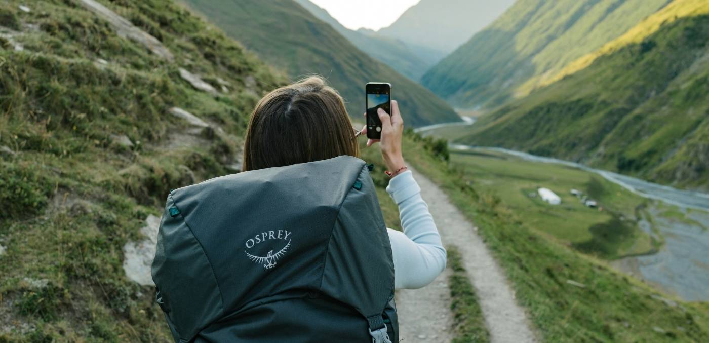 woman taking photo of landscape