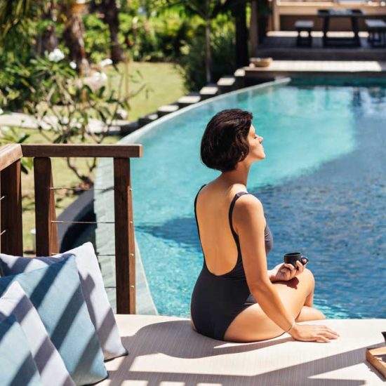 Woman relaxing by pool at Six Senses Fiji