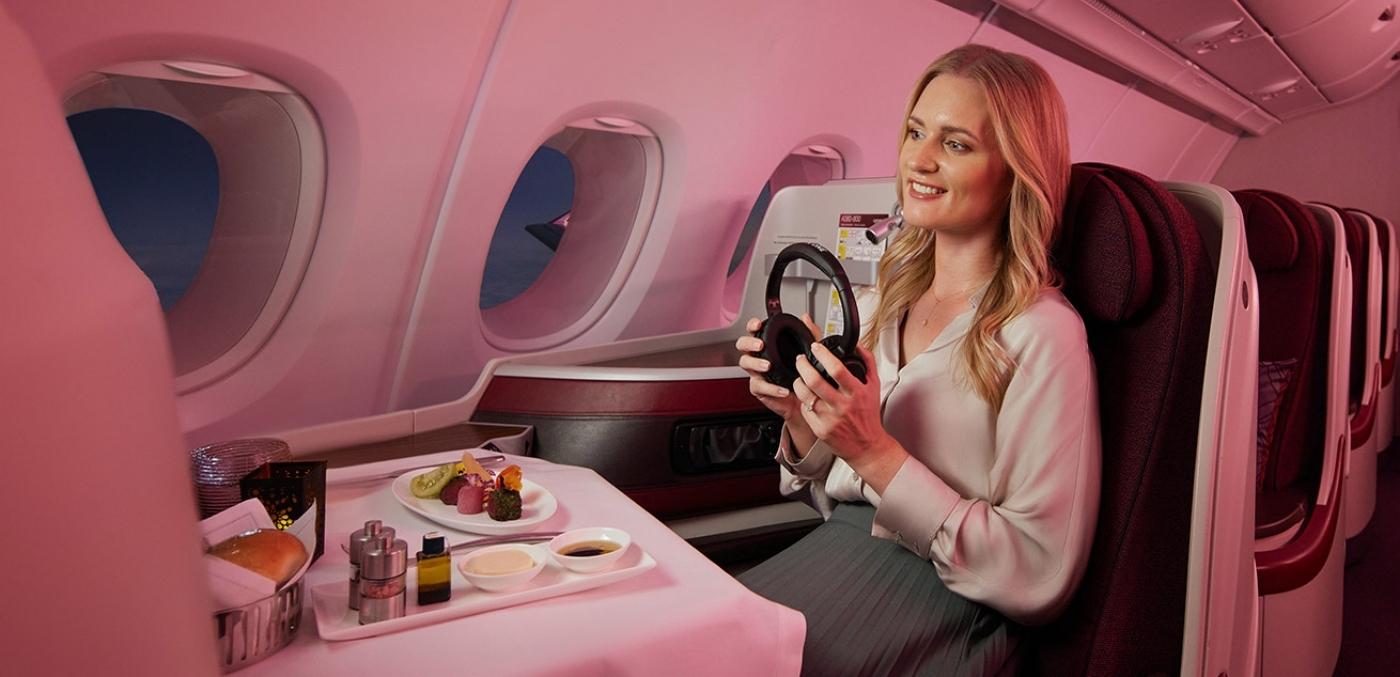 woman sitting in business class on qatar flight